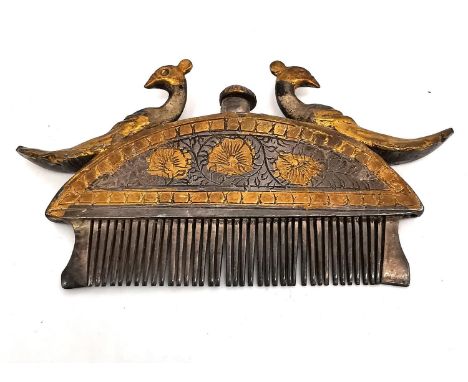 A 19th century Indian white metal and gilt moustache and beard comb of crescent form with a cast peacock sitting on each side