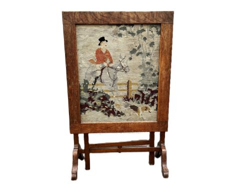 A metamorphic oak frame fire screen with hunt gros point panel, 87 x 56 cm.