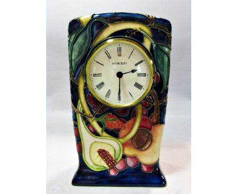 A mantle clock in a Moorcroft ceramic case showing autumn fruits, dated 2000 