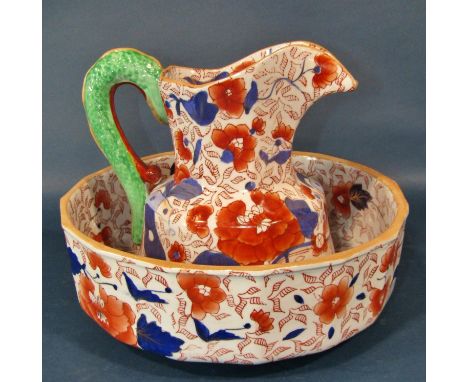 An ironstone jug and basin, the jug with serpent handle, together with a large Victorian meat plate with well and drainer, wi