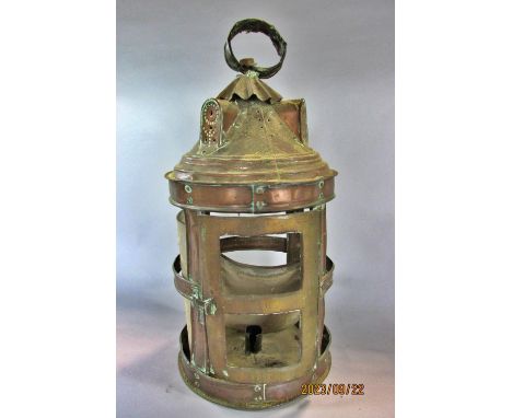 A circular copper candle lantern in need of restoration and a scrolled metal lantern also in need of restoration 
