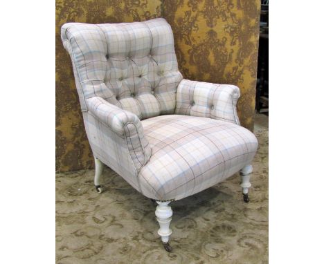 An upholstered easy chair with button back on turned supports 