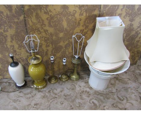 A mustard coloured ceramic table lamp of baluster form with brass fittings, a further oviform lamp in ivory, three further br