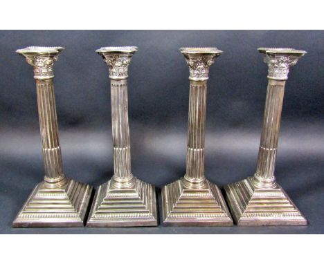 Four silver Corinthian column candlesticks on a stepped base, both Birmingham 1926, different makers, Berton-Gordon and K &am
