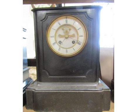 A Victorian black slate mantle clock with eight day striking movement and visible escapement, together with a Smiths Enfield 