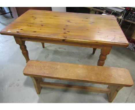 A pine farmhouse kitchen table, 83 cm high x 152 x 84 cm together with an associated pale pine refectory bench, 51 cm high x 