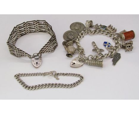 Three silver bracelets comprising a charm bracelet hung with several travel / souvenir related charms, a gate link bracelet a