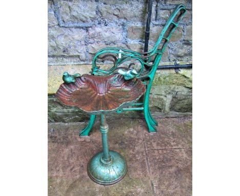 A small weathered cast iron bird bath of shell form with bird surmounts, raised on a central column and dome base, 55cm (full