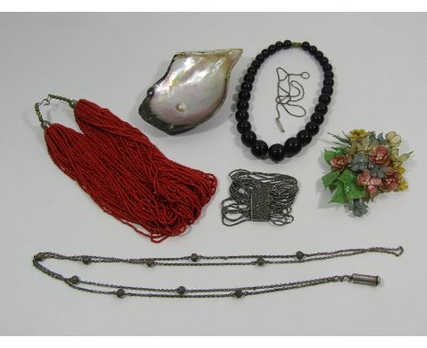 S Mordan white metal propelling pencil hung from a beaded long guard chain, together with a multistrand coral  coloured bead 
