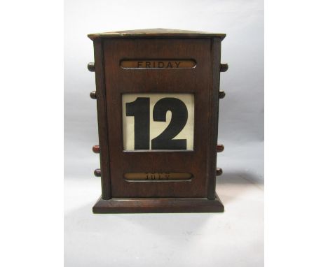 An Edwardian desk calendar in a timber case, together with a set of cantilever balance scales 
