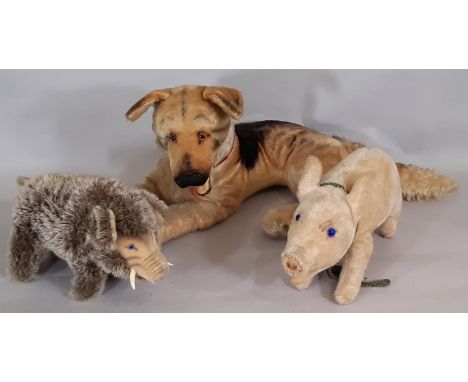 Three vintage toy animals; large Steiff German Shepherd dog 'Arco' lying down, height 27cm (missing pin), a mid 20thC Steiff 