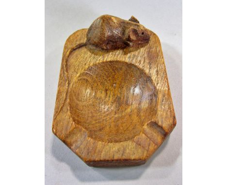 From the workshop of Robert `Mouseman’ Thompson a light oak ashtray with mouse signature. 10cm x 7cm, (Damage to ear) 