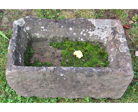 A weathered carved rectangular natural stone trough (probably sandstone) 58cm long x 40cm wide x 20cm deep 