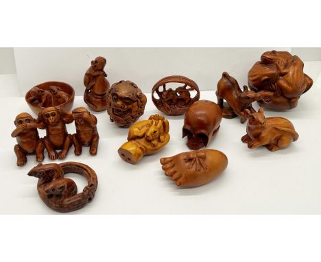 A collection of 22 hardwood polished netsuke, principally creatures, snakes, toads, rabbits, rats, monkeys, together with hum