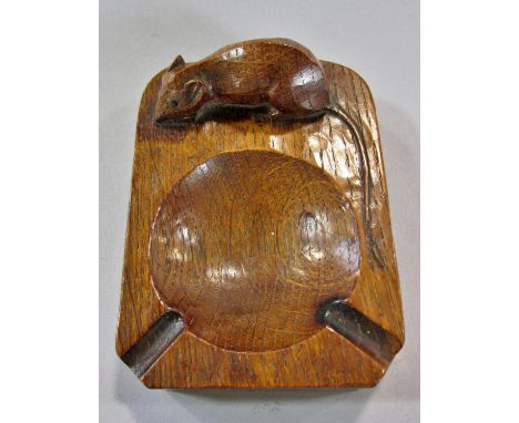 From the workshop of Robert `Mouseman’ Thompson a dark oak ashtray with mouse signature,10cm x 7cm.  (tail broken) 