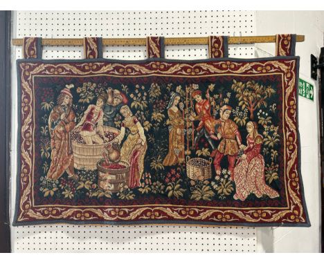 An old style tapestry, of French wine makers harvesting and treading grapes, 96cm x 56cm 