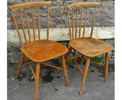 A pair of Ercol stickback kitchen chairs on turned supports 