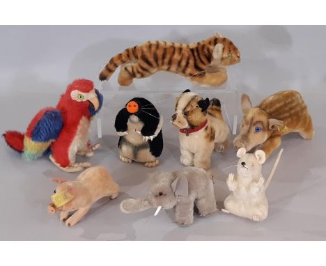 A collection of small vintage Steiff animals including 1950's 'Bully' dog height 11cm with pin in ear, 1960's boar with pin i