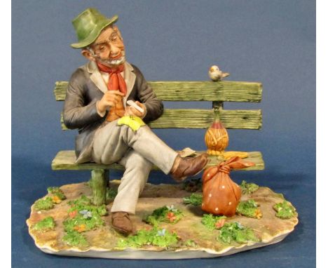 An Italian bisque figure of a tramp upon a bench and two further examples 