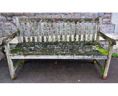 A weathered teak three seat garden bench with slatted seat and back, 150cm long 