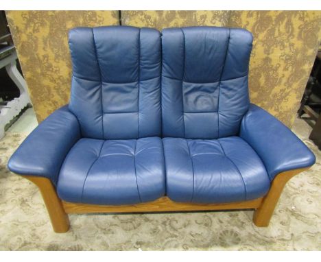 A Stressless Windsor high back two seat sofa in Paloma Oxford blue leather and beechwood together with a matching upholstered