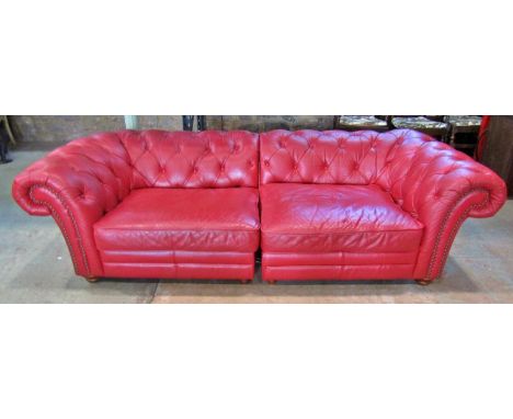 A Victorian style Chesterfield sofa with button finish, upholstered in a red leather colourway, 240 cm wide 