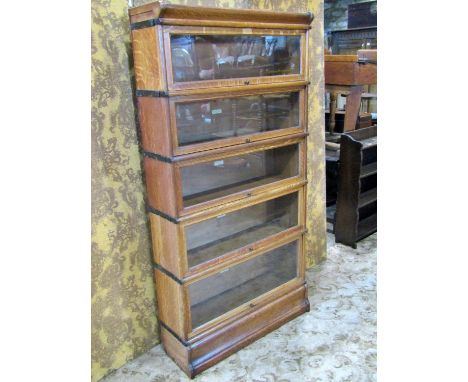 A Globe Wernicke &amp; Co Ltd oak floorstanding five sectional library bookcase with 'up and over' rectangular glazed panelle