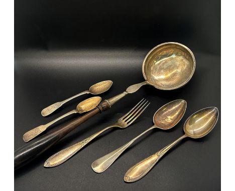 A selection of continental silver flatware to include six serving spoons, two dessert spoons, a fork and a ladle 
