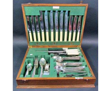 An oak Walker &amp; Hall canteen of silver plated cutlery for six settings (one dessert spoon missing), a silver napkin ring 