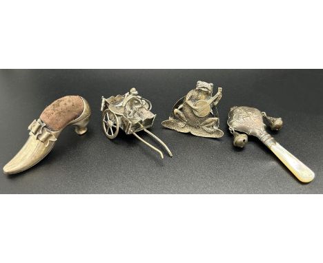 A collection of miniature silver items including a frog playing the mandolin, a menu holder, a small mother of pearl and silv