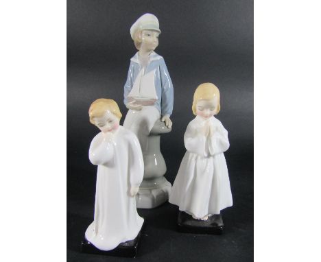 Two Royal Doulton figures, Bedtime Prayers and Darling and a further Lladro figure of a boy with a boat 