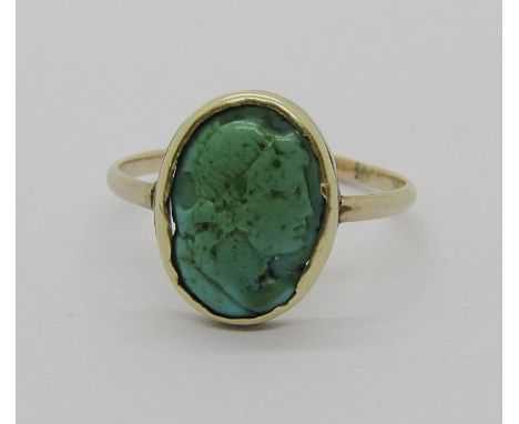A possibly ancient carved turquoise intaglio ring, decorated with portrait of a classically presented figure in side profile,
