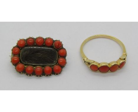 19th century yellow metal mourning brooch containing a lock of hair within coral surround, 3.7g, together with a further anti