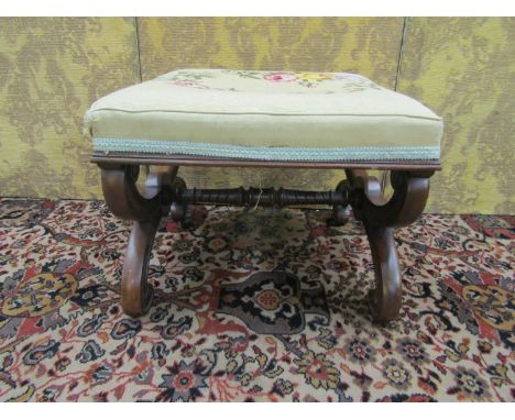 A late Regency mahogany X framed centre stool with carved and moulded detail, with hand worked floral tapestry seat, 50cm squ