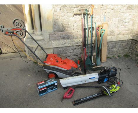 A collection of gardening equipment including a Flymo roller compact 4000 electric mower together with a leaf blower, a small