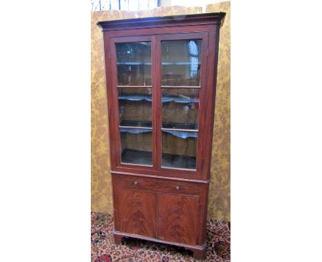 A Georgian pine cabinet of full height with original painted detail to simulate flamed mahogany, the lower section enclosed b