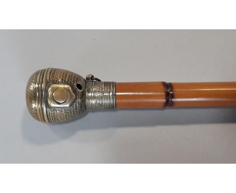 An unusual 19th century novelty walking cane, the globular screwing brass knop handle enclosing An incorporated lighter mecha