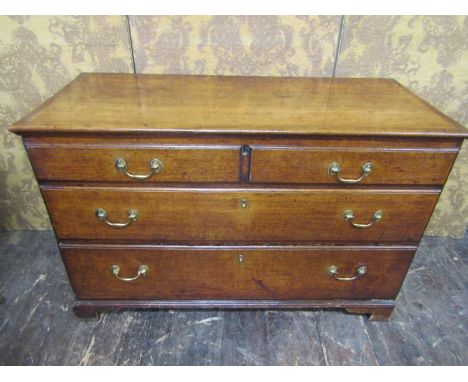 A Georgian oak countrymade mule chest with rising lid, with lower deep frieze drawer below three further dummy drawers all wi