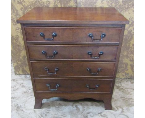 A small good quality Georgian style mahogany chest of four long graduated drawers with shaped apron and splayed bracket feet,