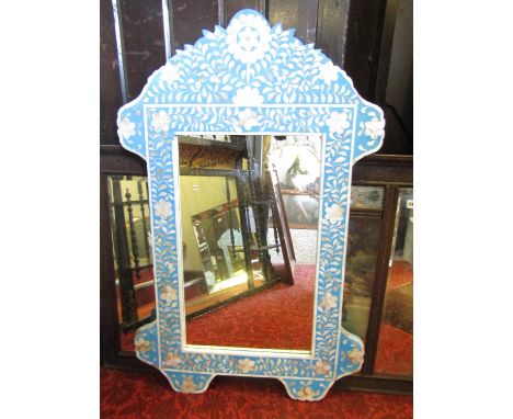 An Indian wall mirror the turquoise background inlaid with mother of pearl panels set within a shaped outline, 110cm x 70cm 