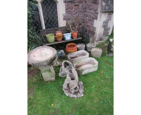 A two seat garden bench with weathered timber lathes, together with a pair of light steel jardinières and a collection of com