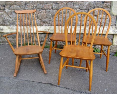 Three Ercol hoop back kitchen chairs with elm seats and turned supports together with a further Ercol rocking chair with stic