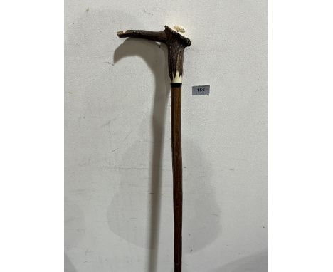 A hazel walking stick, the antler handle with integral whistle and carved with a fish 