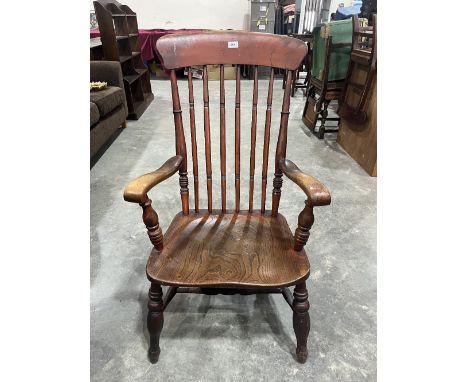 A Victorian stick back elbow chair with elm seat on splayed turned legs 