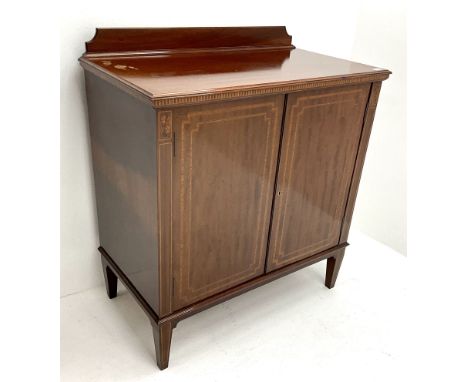 Edwardian inlaid mahogany cabinet, raised shaped back, two doors enclosing fitted interior, square tapering supportsDimension