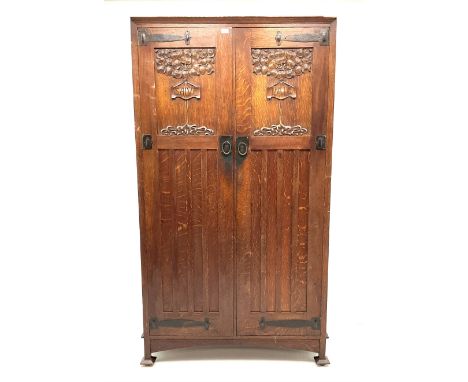 Shapland and Petter of Barnstaple - Arts &amp; Craft style oak heavily carved wardrobe, double door enclosing fitted interior