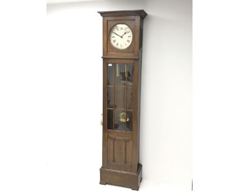 Early 20th century oak longcase clock, projecting cornice over plain dial with Roman numerals, the trunk enclosed by astragal