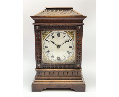 Early 20th century walnut cased mantel timepiece clock, sloping top over glazed door with carved frame, silvered Roman dial w
