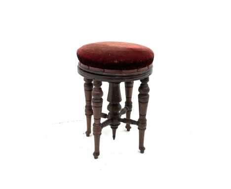 Mahogany swivel stool, seat upholstery in a wine red fabric, turned supports and stretchersDimensions: Height:&nbsp;38cm&nbsp