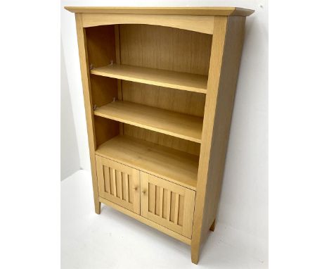 Light oak open bookcase, two shelves above two cupboard doors, stile supportsDimensions: Height:&nbsp;141cm&nbsp; Length/Widt
